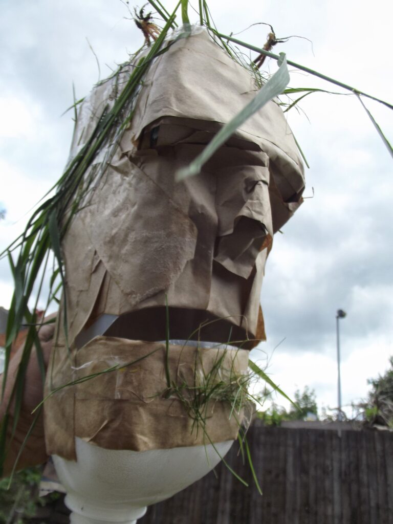 Mask from a bottle, tape and grass