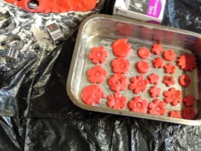 Image of baking tin with lots of pink flower-shaped cookies inside