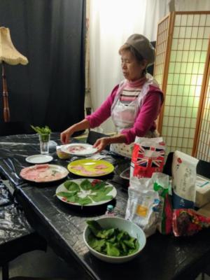 Image of woman standing next to table with Japanese sweets and ingredients displayed